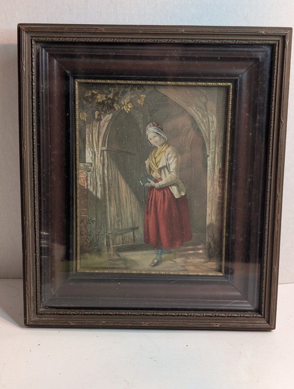 An antique artwork is a George Baxter print titled 'Returning for Prayer'.